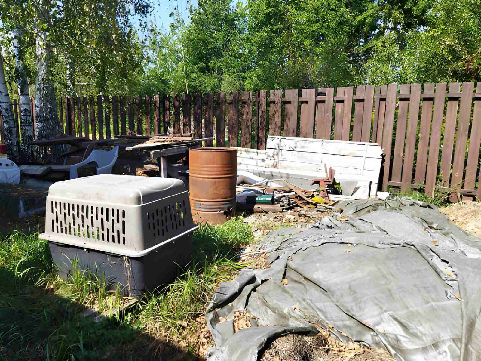 A backyard with various items, including a pet carrier
